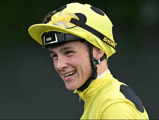 jockey wearing clear racing goggles with rain on the lens